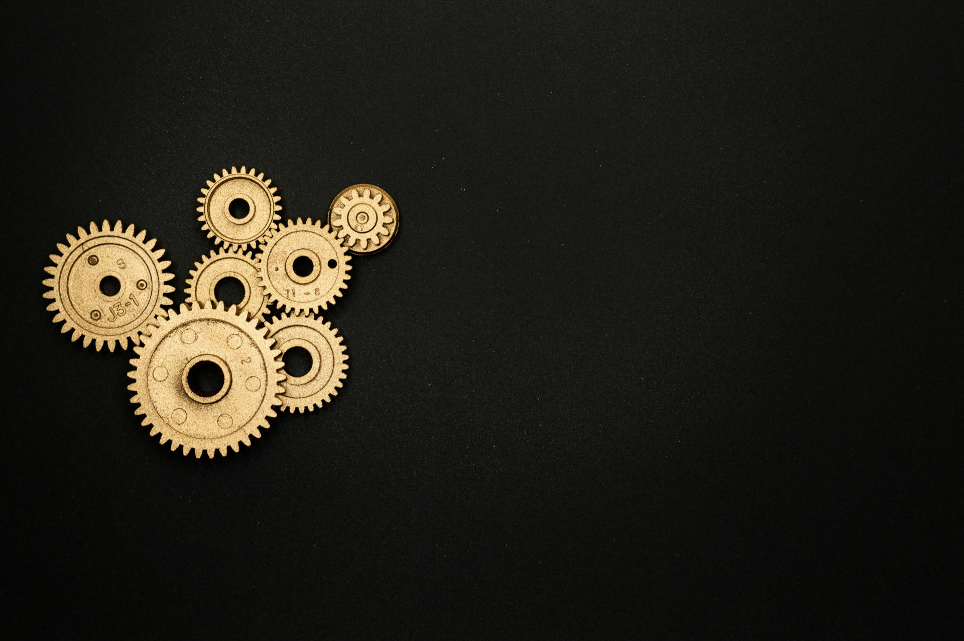 A set of meshed gears on a black background.