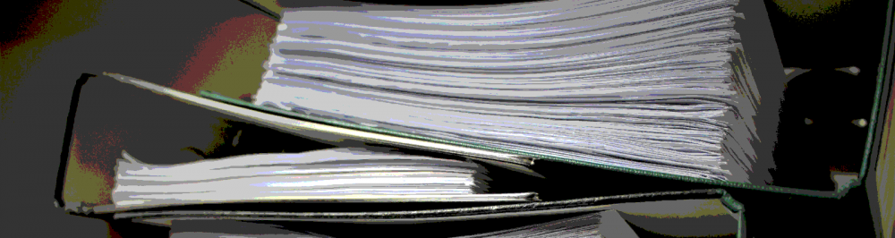Stack of papers, alluding to policy that is large and out of control.